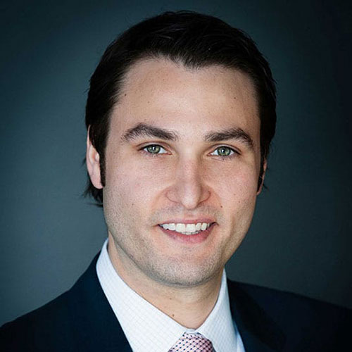 Professional portrait of Aaron Kaplan in a suit