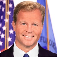 Professional portrait of Brian Quintenz in a suit