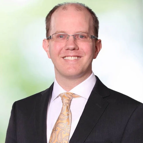Professional portrait of Carleton Goss in a suit and tie