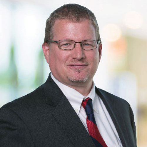 Professional portrait of Jason Emery in a suit
