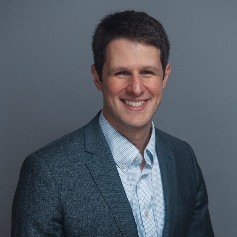 Professional portrait of Joe Medioli in a suit