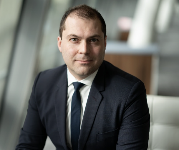 Professional portrait of Olivier Fines in a suit and tie