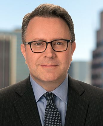Professional portrait of Richard B. Levin in a suit and glasses