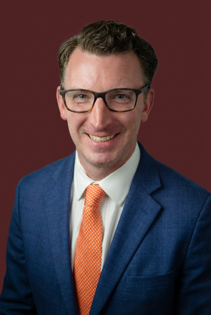 Professional portrait of Tim Kotzman in a suit and tie