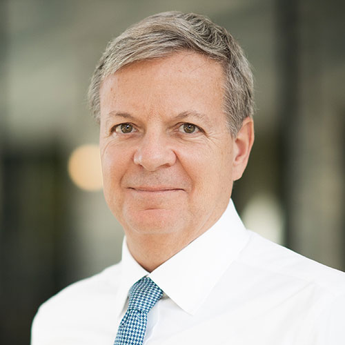 Professional portrait of Tom Zschach in a suit and tie